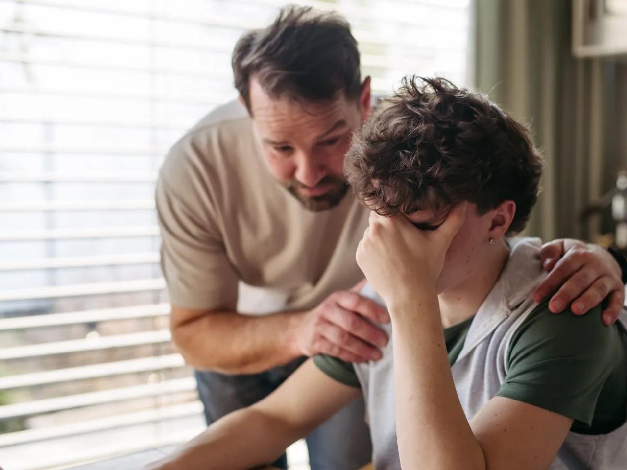 Family supporting loved one or Parents comforting teenager