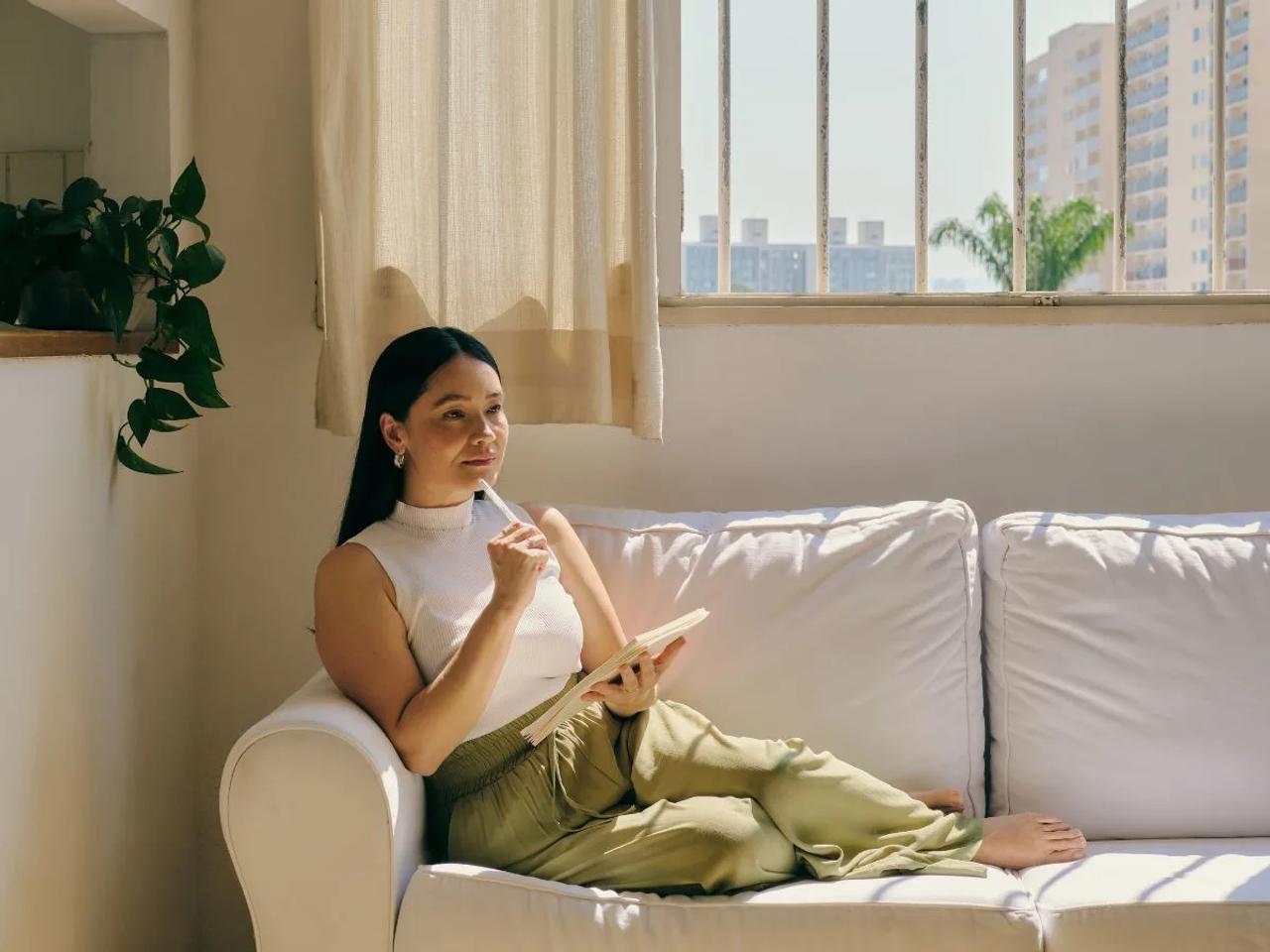 Self care mental health or Person relaxing with tea journal