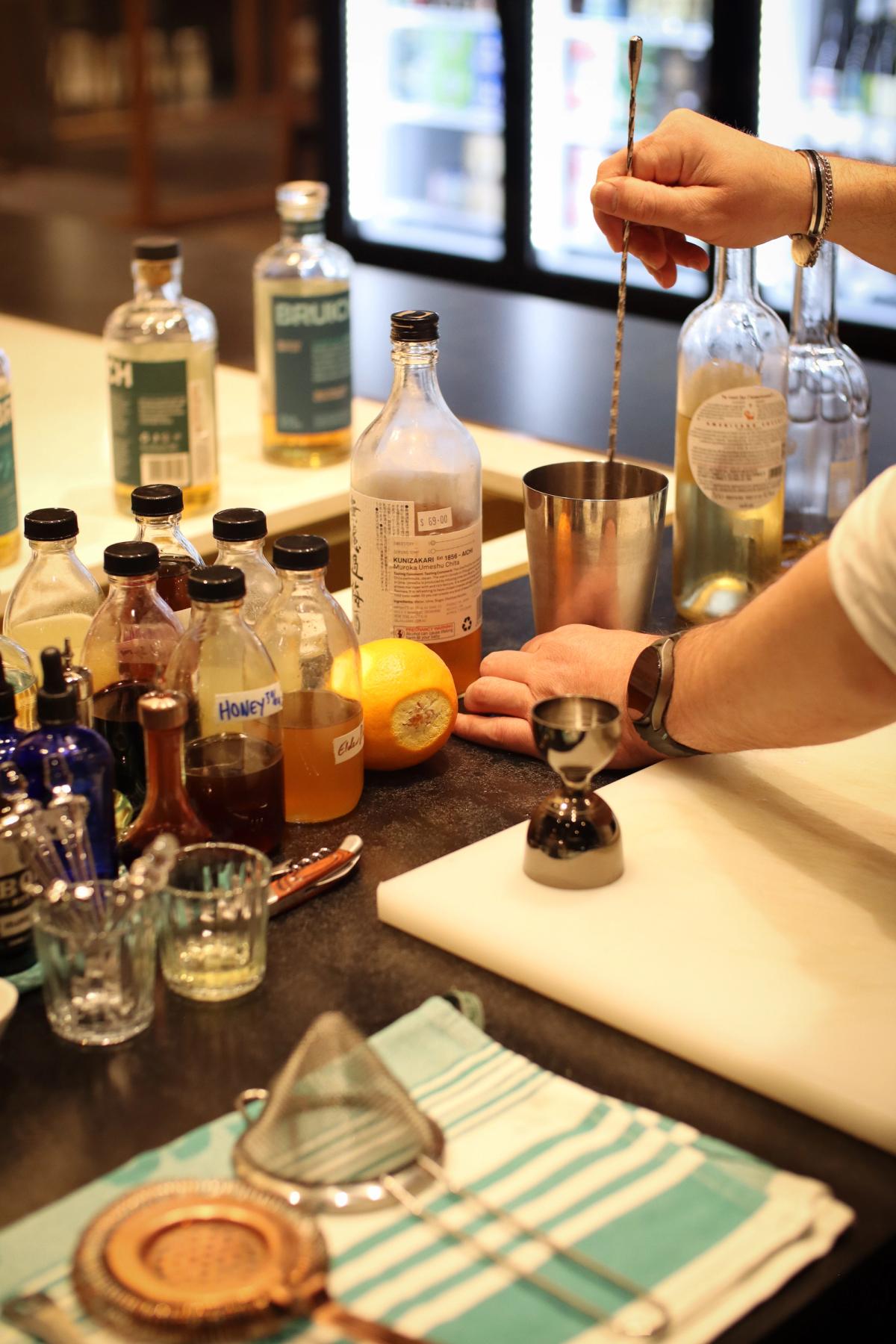 barman preparing cocktails at the island bar