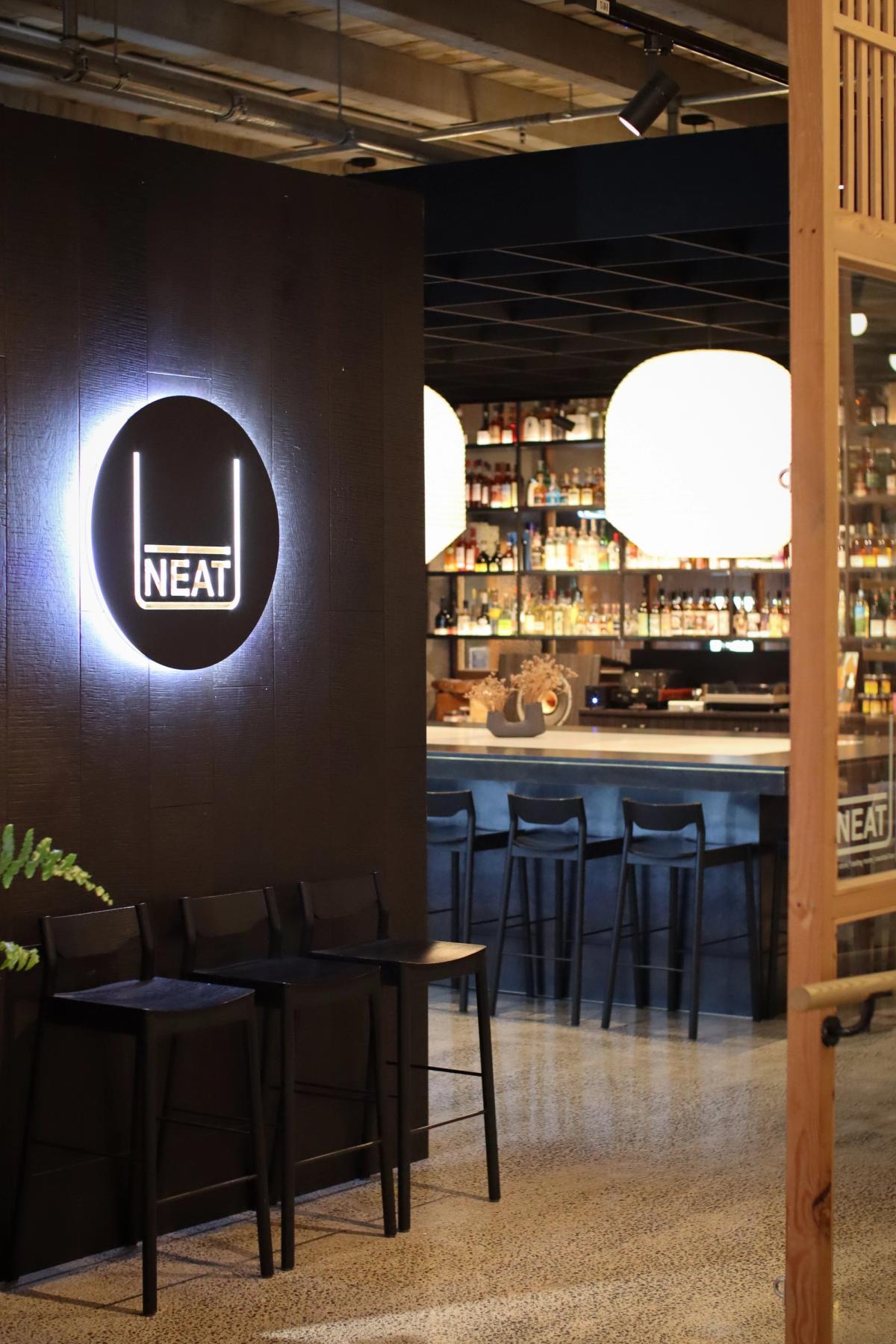 rough sawn ebonised timber wall cladding entrance to Neat Tasting Room