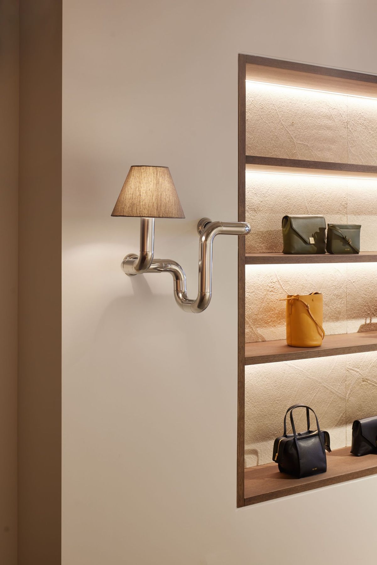 interior photography of art oblect light wall sconse next to custom built-in display shelving