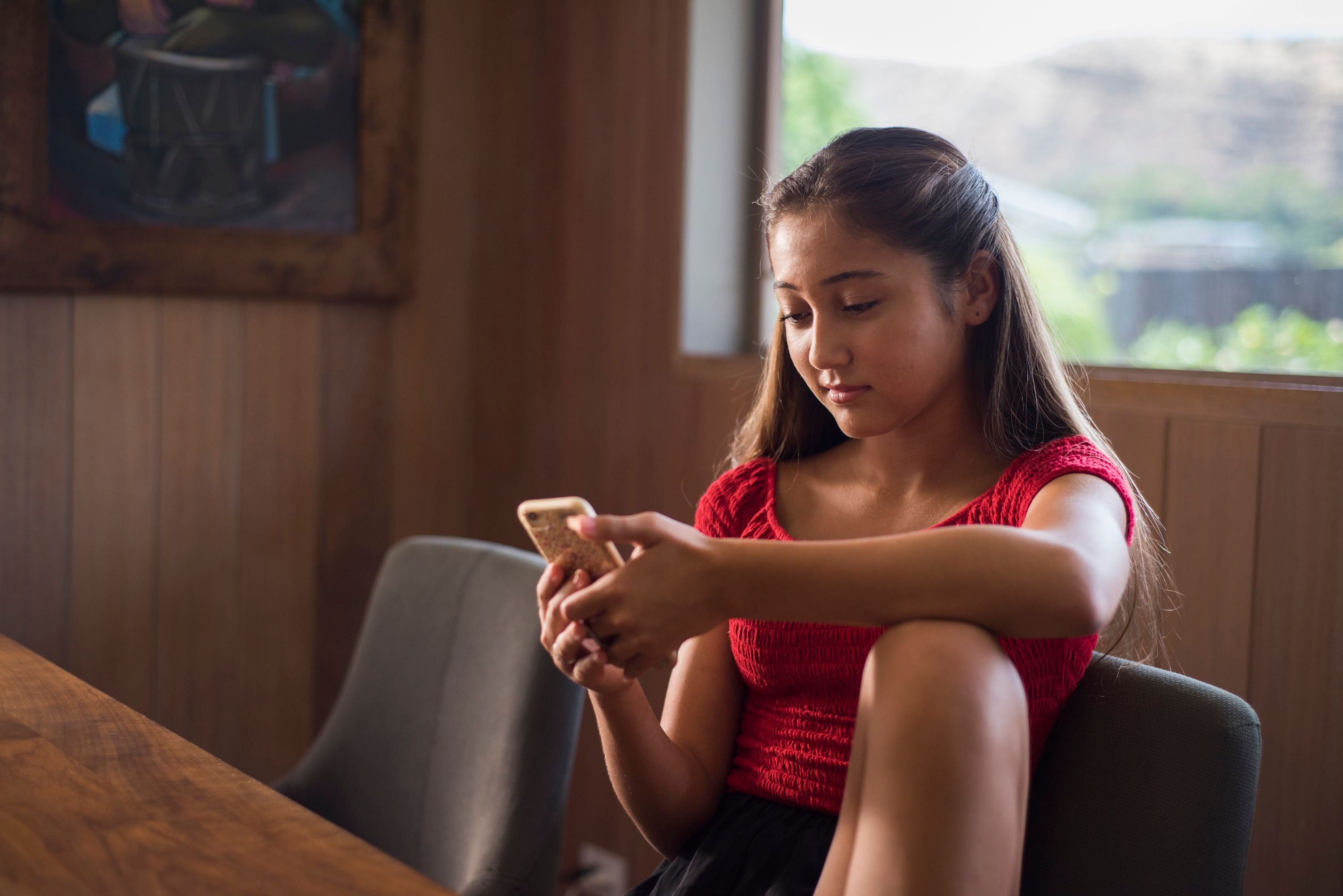 Teenage girl looking at her phone
