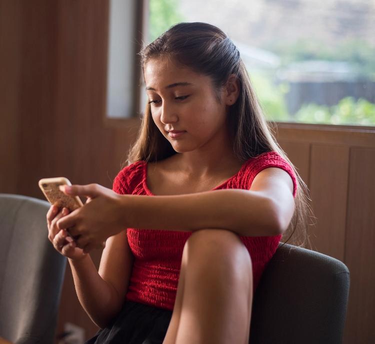 Teenage girl looking at her phone