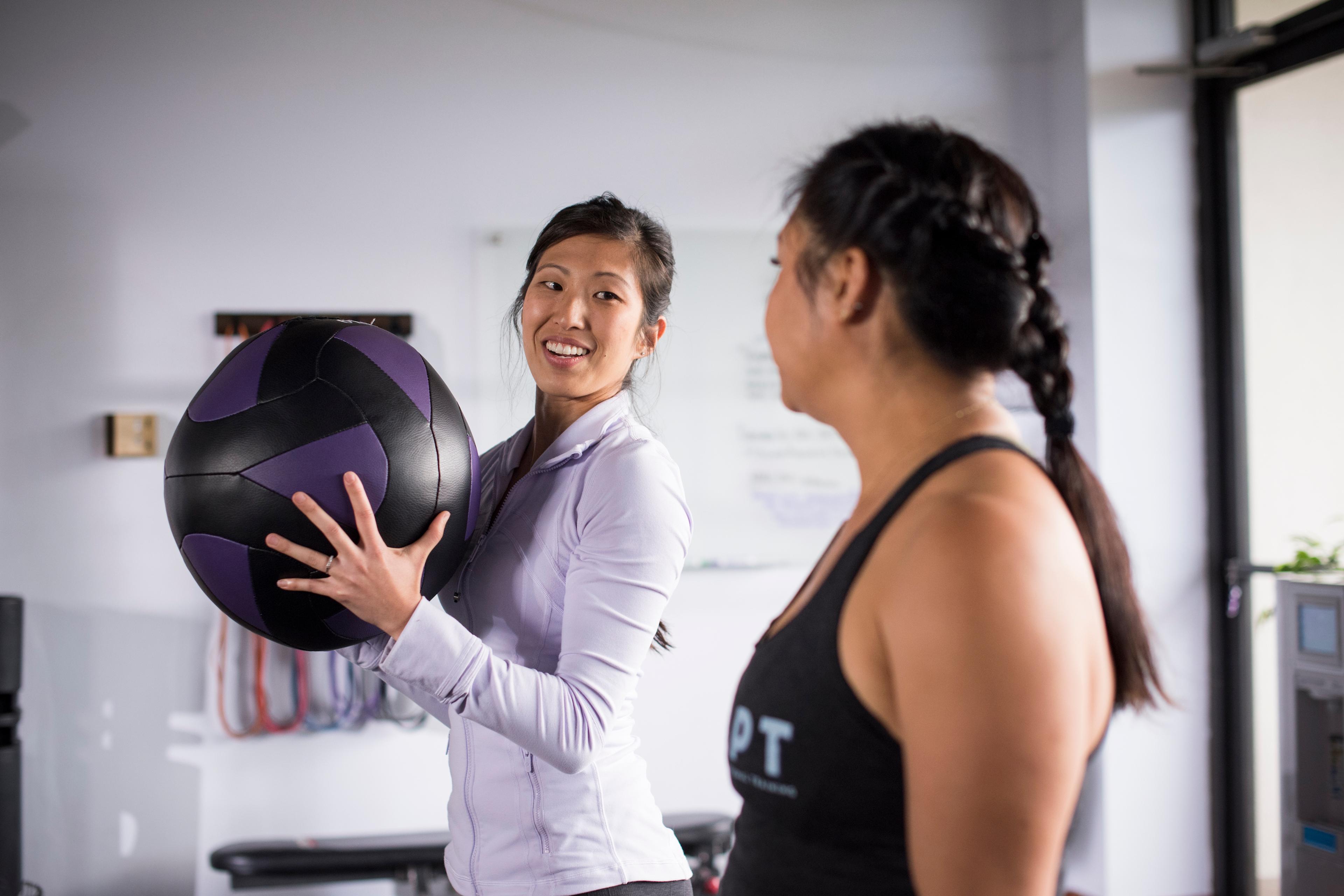 Video cover image shows entrepreneur Candace Nakasone demonstrating how to use a medicine ball to a trainee