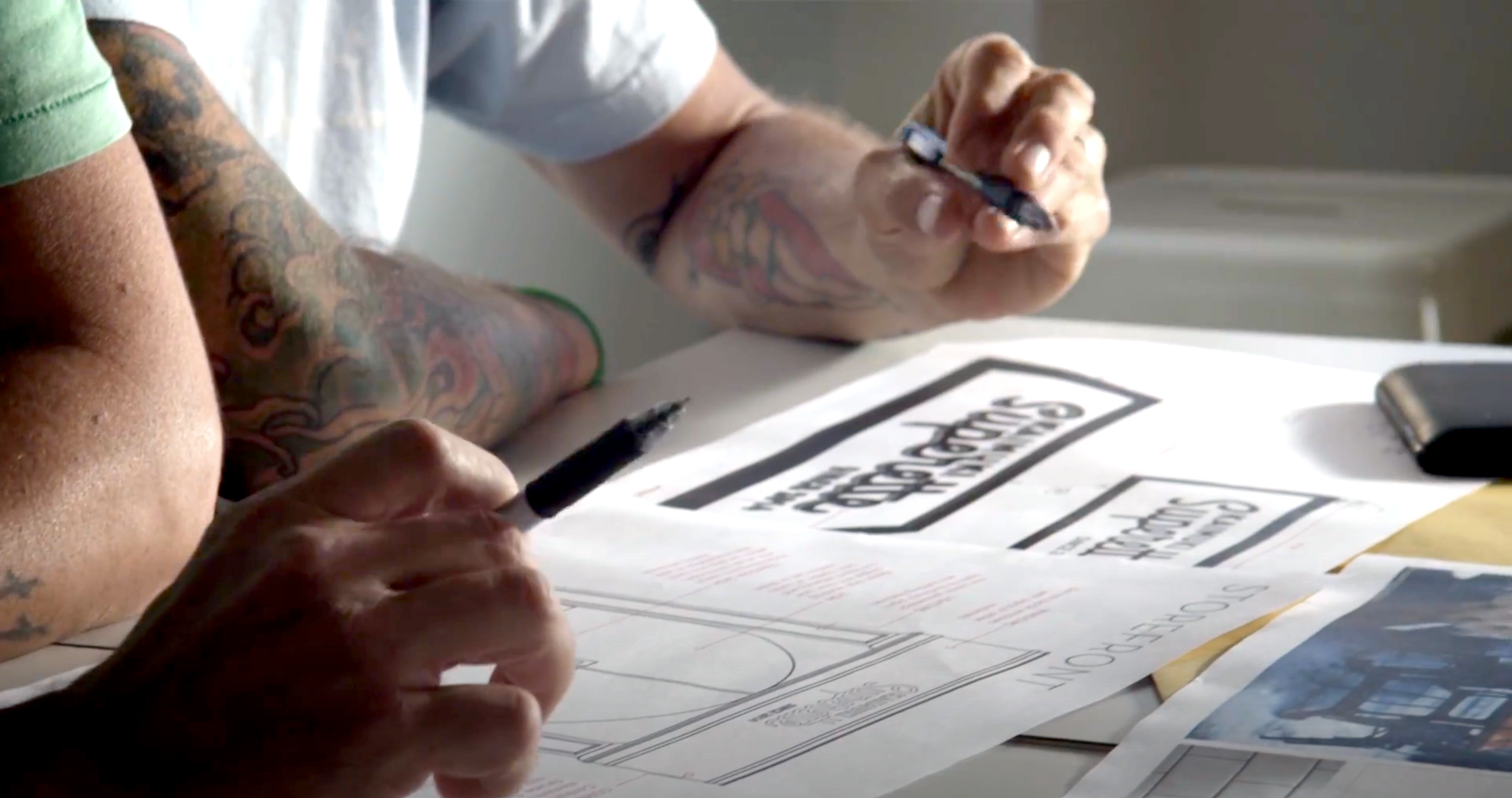 Video cover image shows Entrepreneurs Ed and Dave looking at blueprints