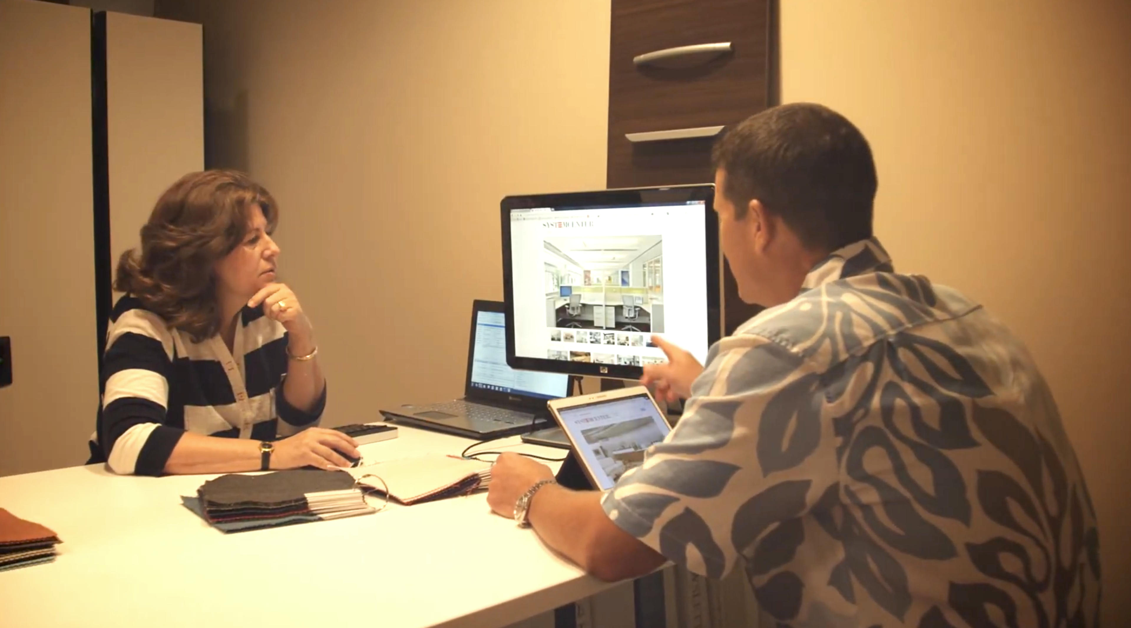 Video cover image shows Entrepreneur Stephan Edwards with his team around a table looking at a rendering on a TV screen