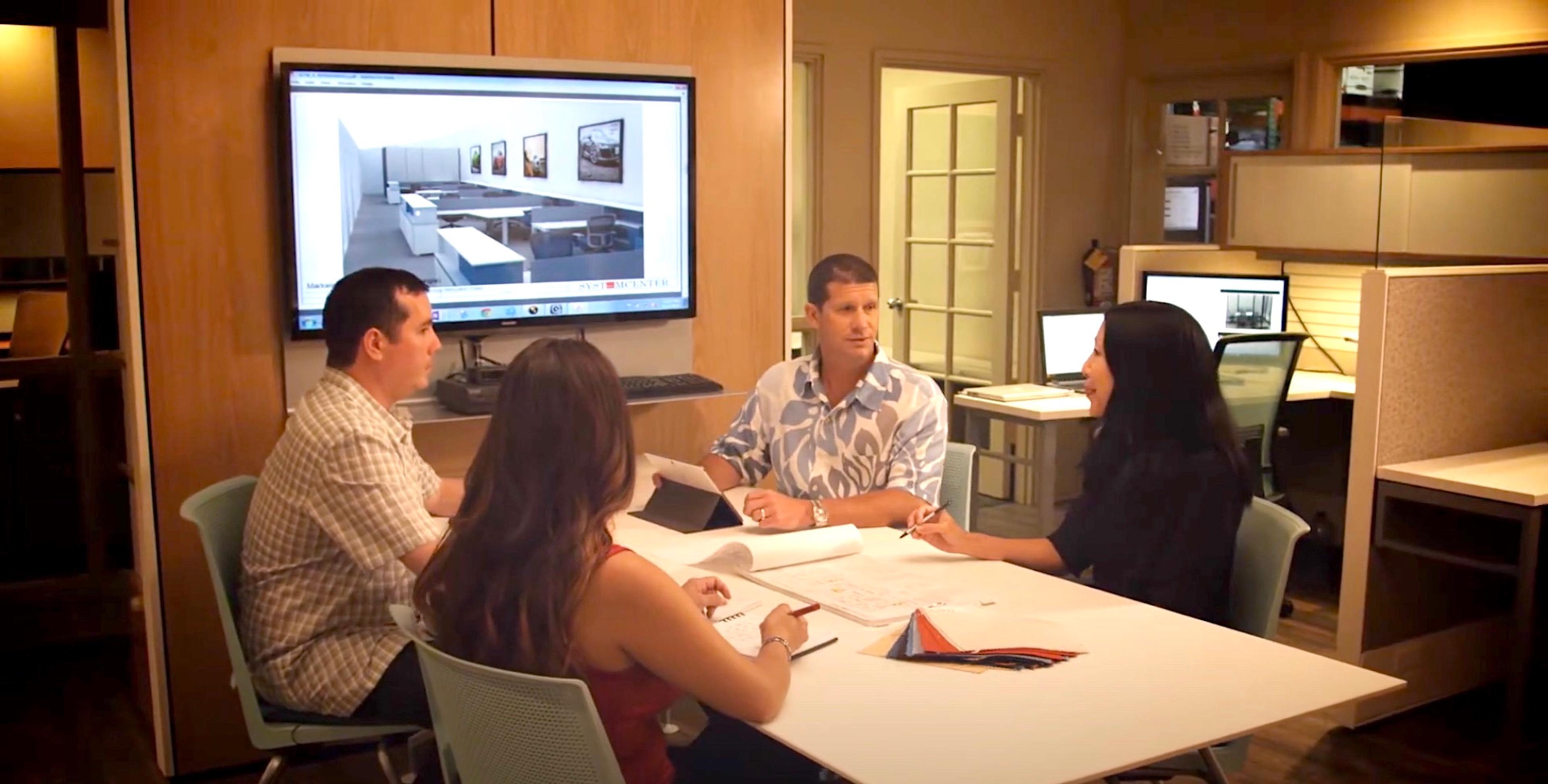 Video cover image shows Entrepreneur Stephan Edwards with his team around a table looking at a rendering on a TV screen