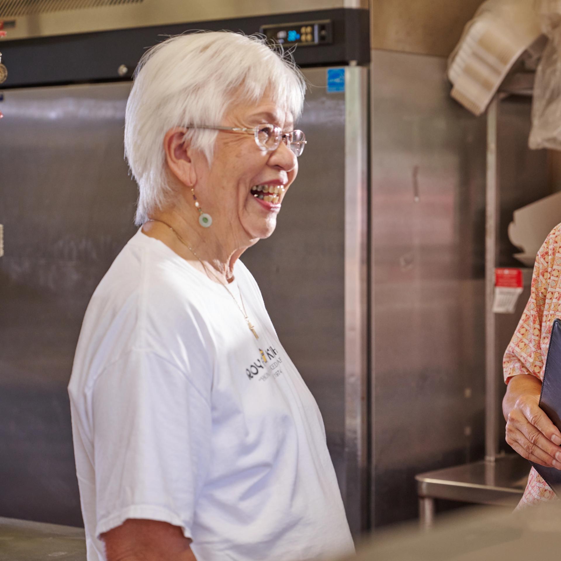 HNB Entrepreneur, Liana Benn, pulling out a tray of baked manapuas