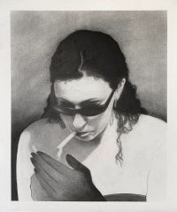 Person with long hair wearing sunglasses is lighting a cigarette with one hand while holding it close to their mouth.