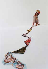 A woman dressed in colorful traditional clothing stands on a white surface holding a long, winding line of connected fabric pieces that stretch downward.