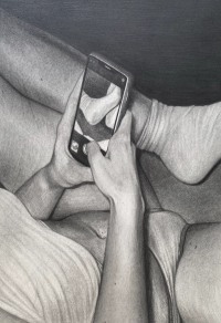 A person wearing a light-colored shirt and socks is holding a smartphone that displays a close-up image of their foot.