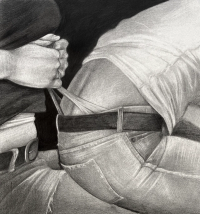 One person is pulling the waistband of another person's pants while both are wearing casual clothing.