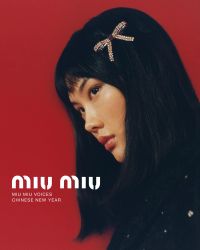 A person with straight black hair and a decorative hair clip is shown in profile against a red background with white text reading "Miu Miu Voices Chinese New Year."