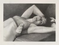 A woman is lying down with arms raised behind their head, wearing a bra and connected to a milk pump with a tube attached to their chest.