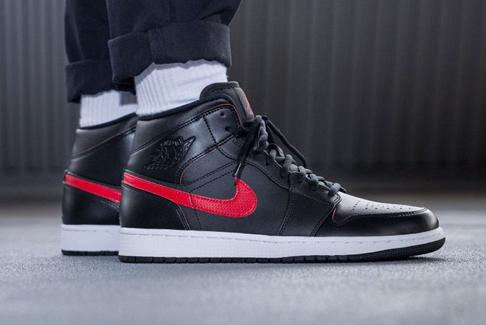 black and white jordan 1 with red swoosh