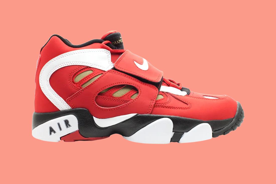 nike air diamond turf ii red sneaker on a pink background