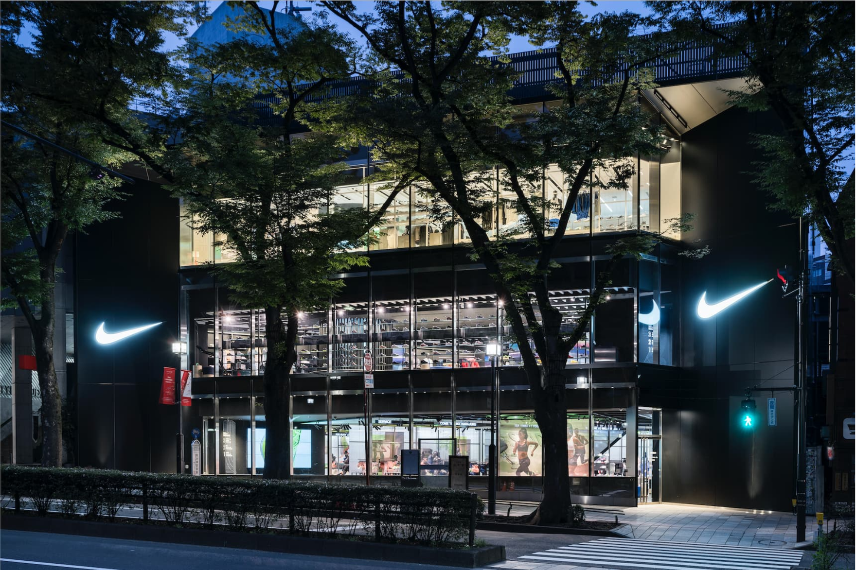a Nike store at night, with glass windows revealing the interior