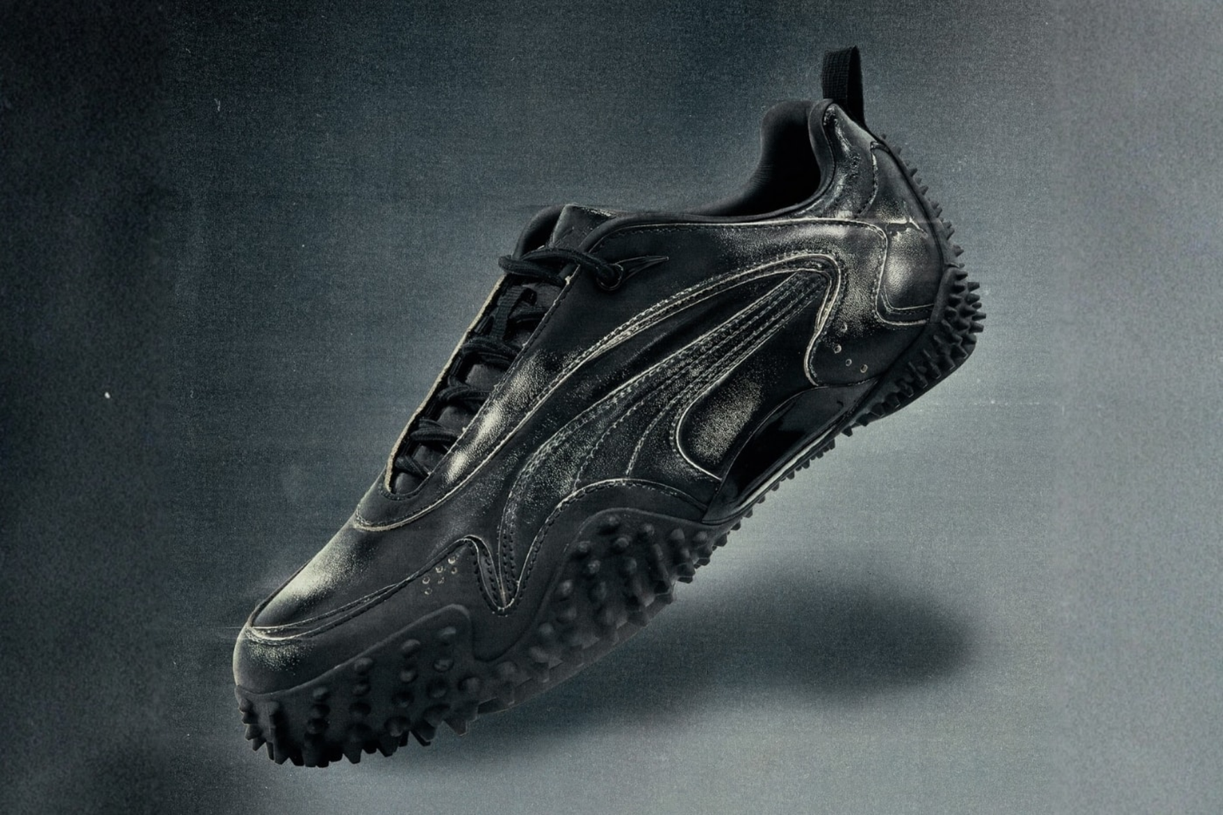 black puma mostro sneaker on black gradient blackground