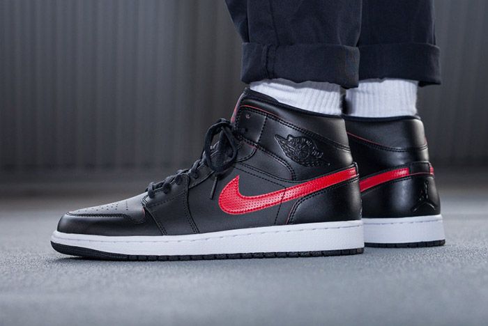 black jordan 1 with red swoosh