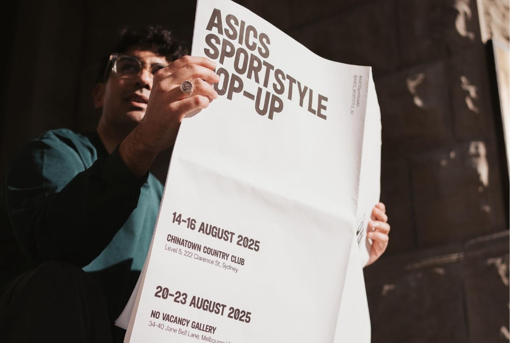 Man reading a newspaper with headline about ASICS Pop-ups