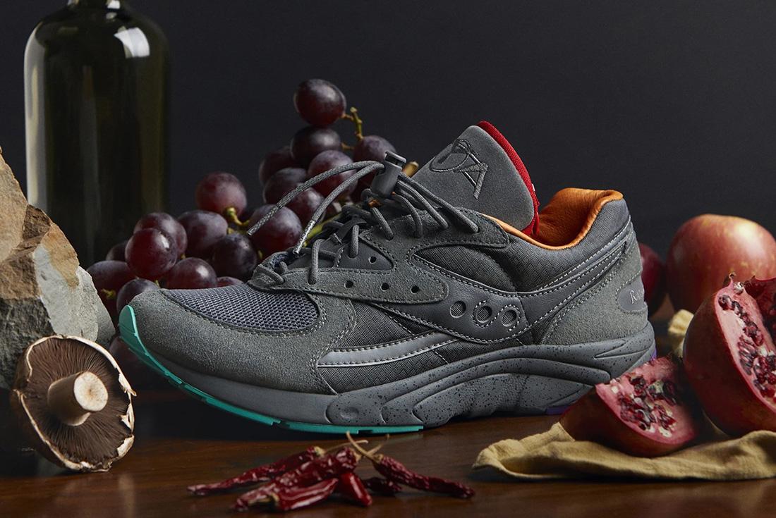 Grey Saucony sneakers weed shoes on wooden table with fruit