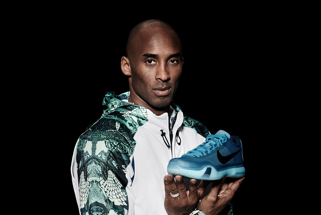 Kobe bryant with Nike shoe in hand