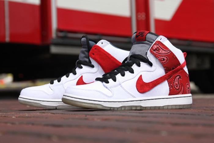 White and red nike sneakers wee shoes on brick surface