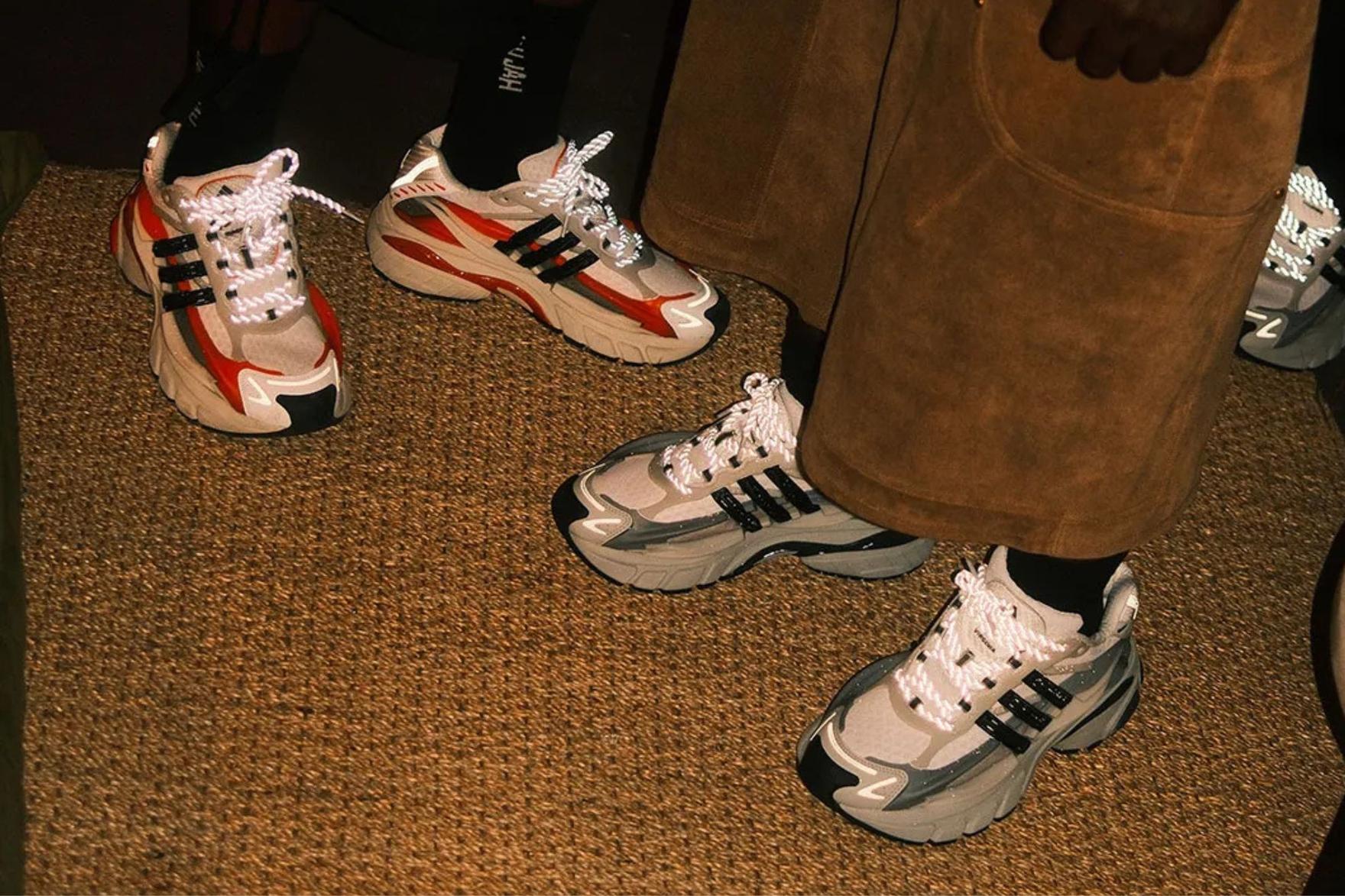 Two pairs of adidas jellyfish sneakers on-foot on carpet
