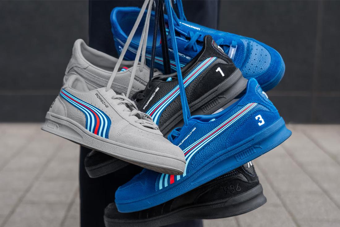 Blue and silver puma porsche sneakers hanging by laces