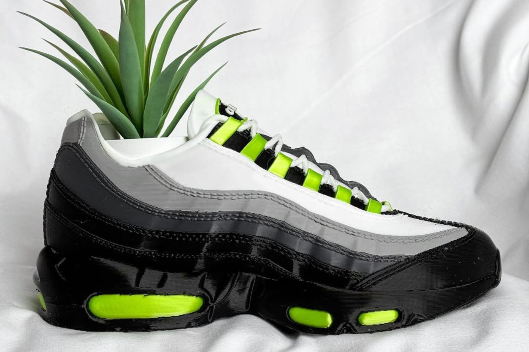 A planter version of the air max 95 neon against a white backdrop