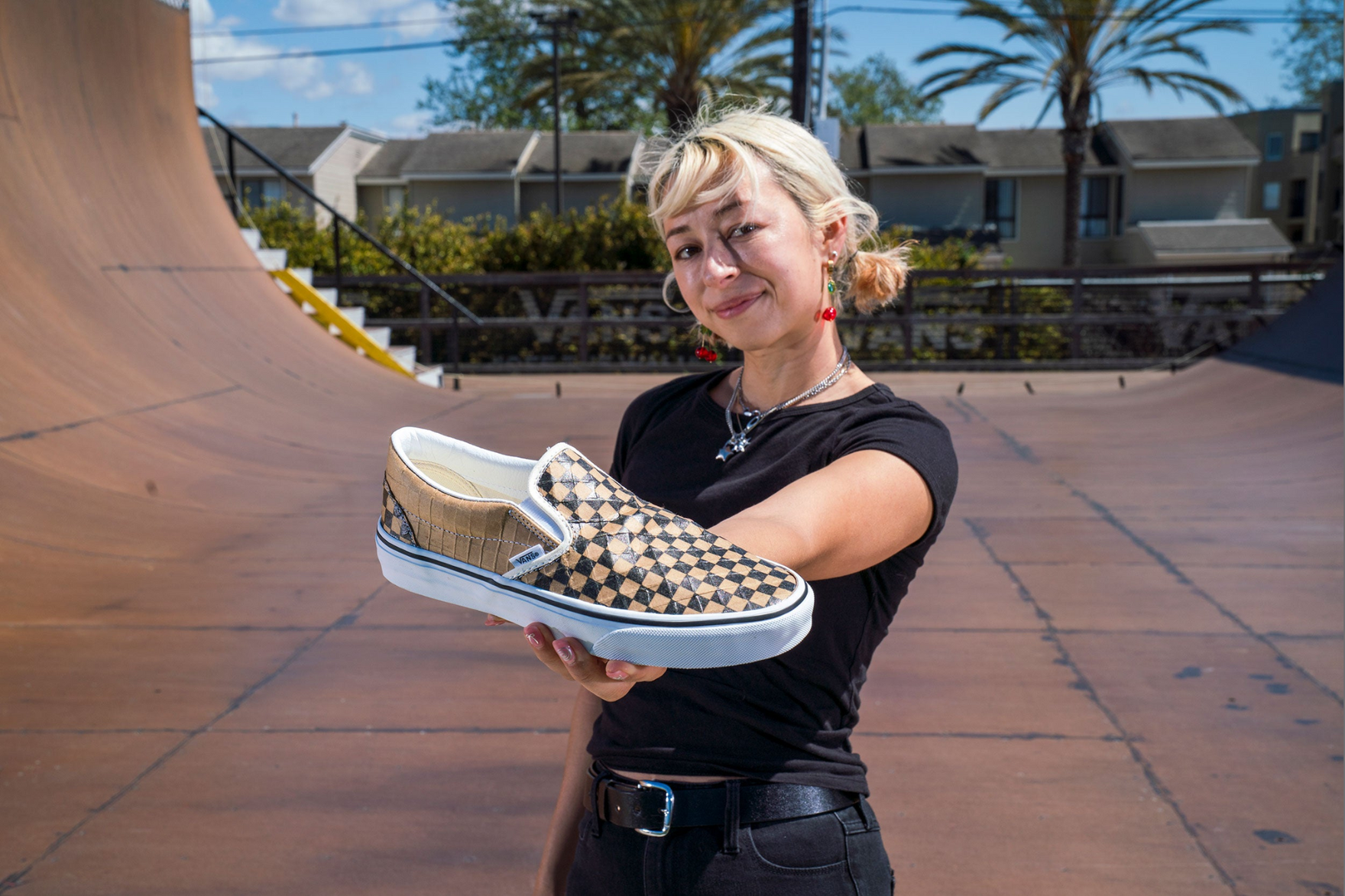 a photo of Lizzie Armanto holding a vans sneaker in her hand