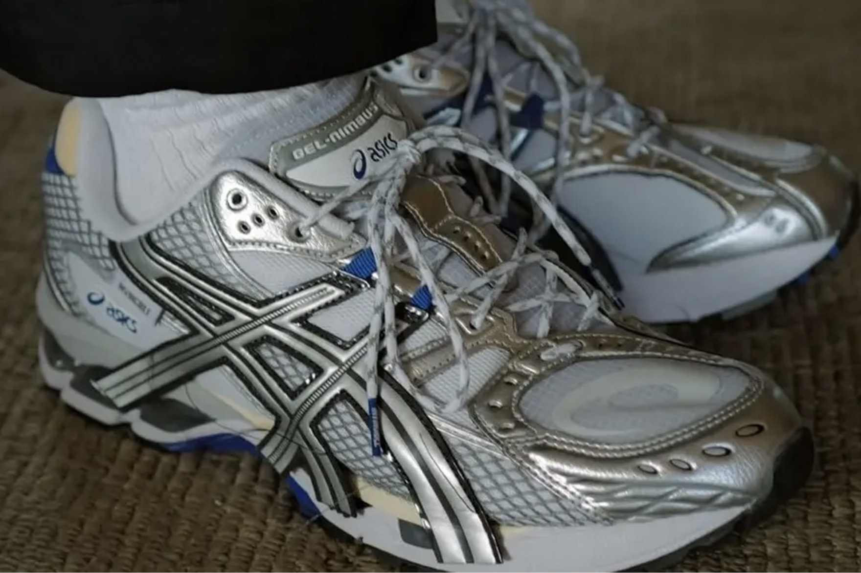 a super zoomed in shot of a shiny silver sneaker on foot
