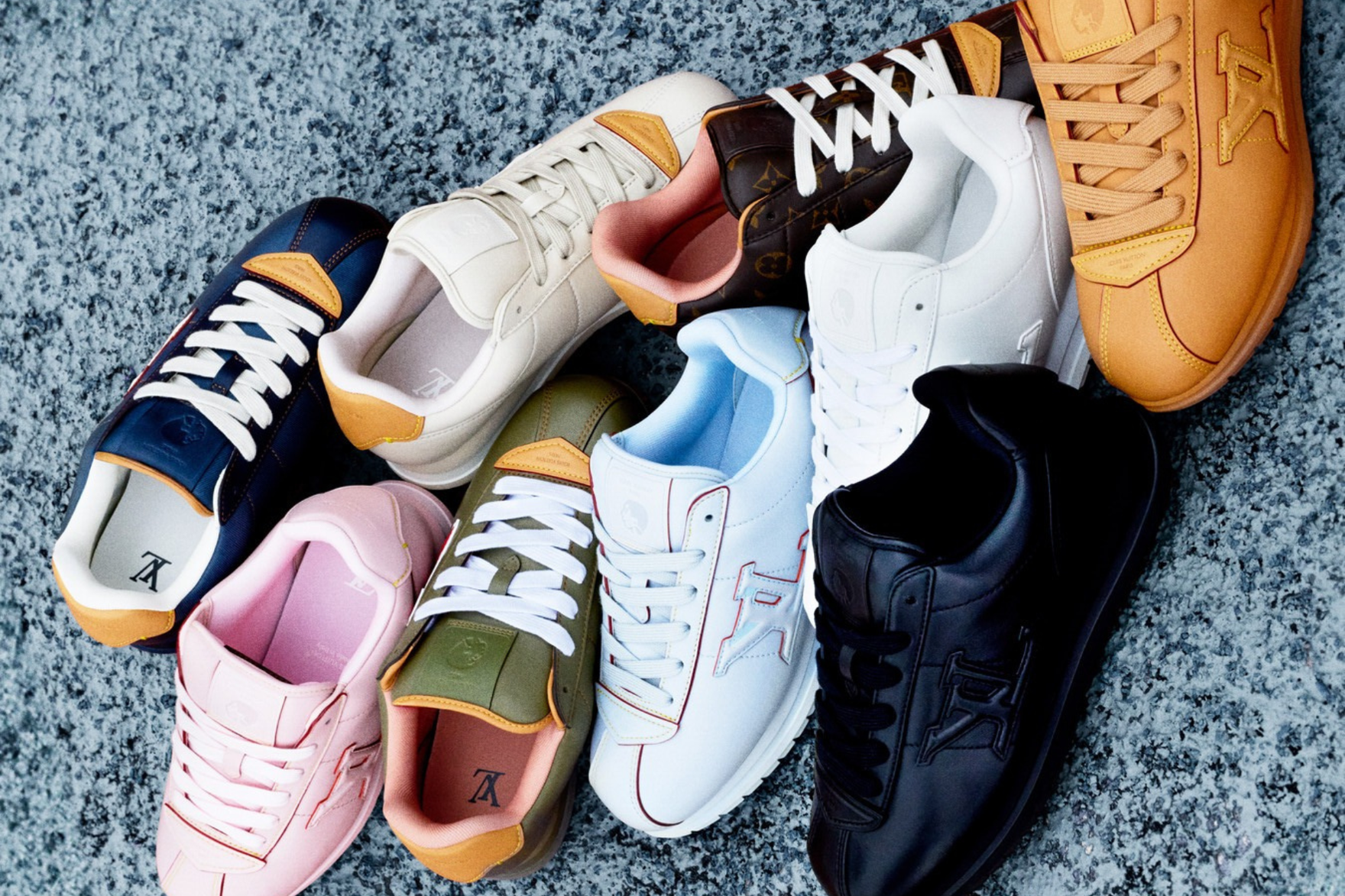 a pile of sneakers from louis vuitton on a blue carpet