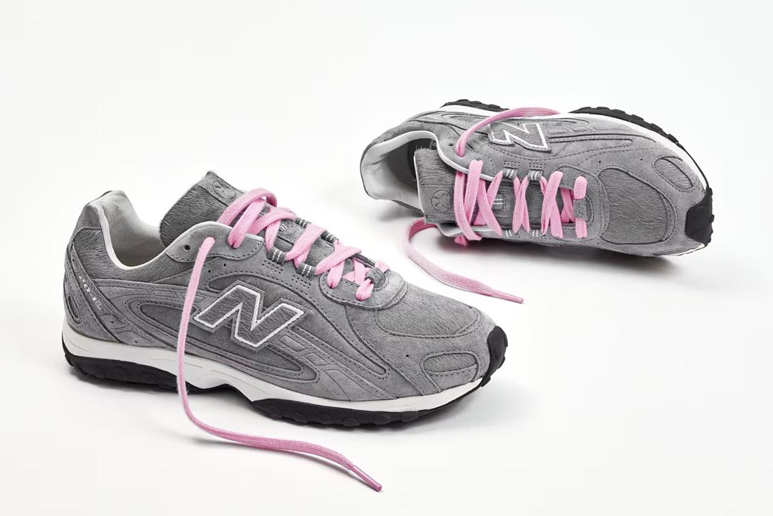 new balance grey and pink sneakers on white background