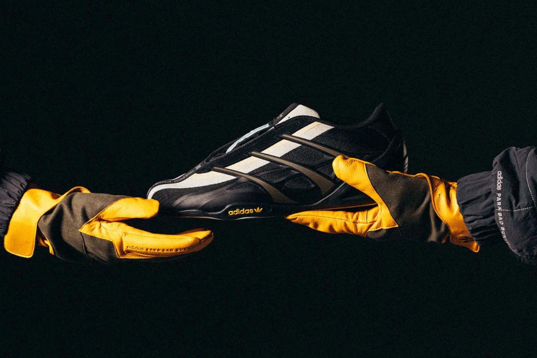 adidas adiracer GT sneaker held with yellow racing gloves