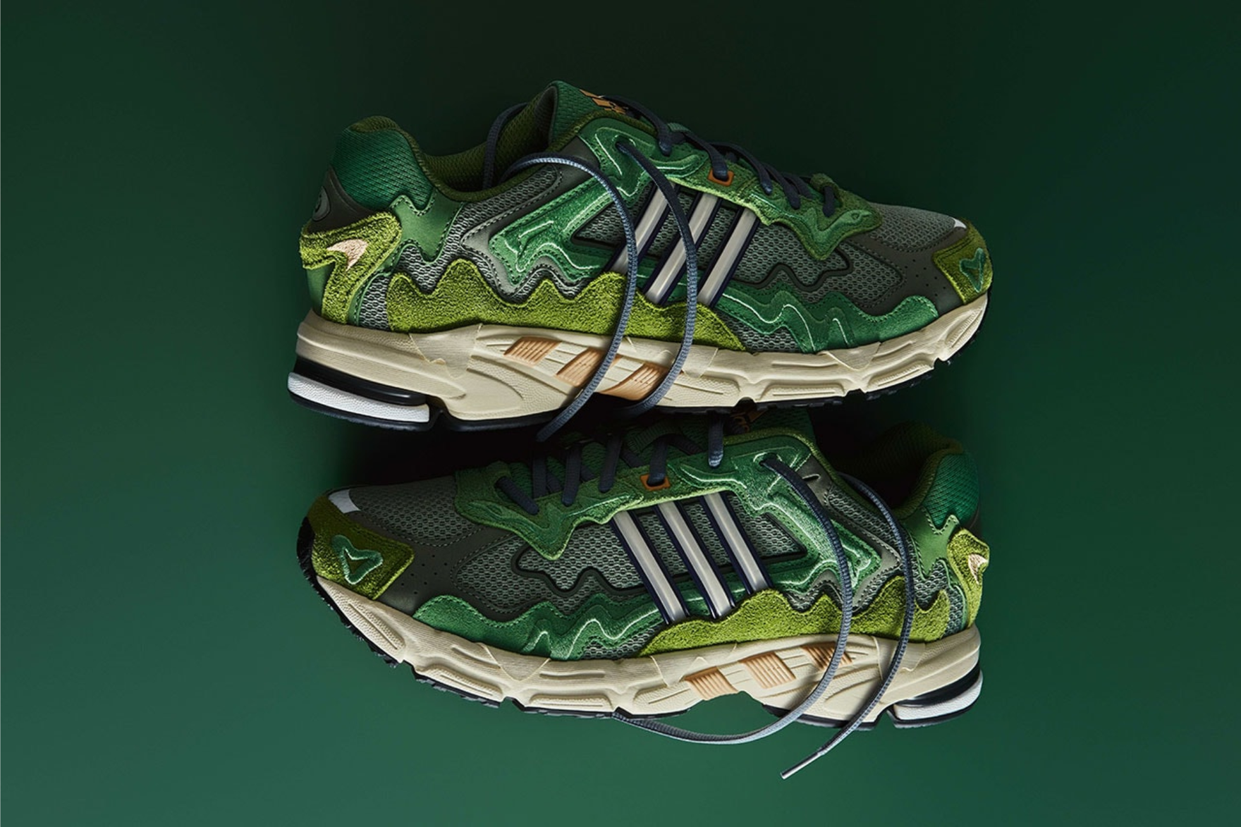 green adidas sneakers on a green surface