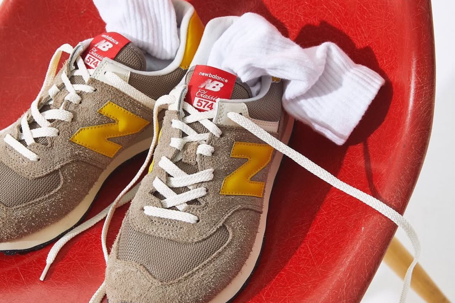 brown and yellow new balance sneaker on red chair
