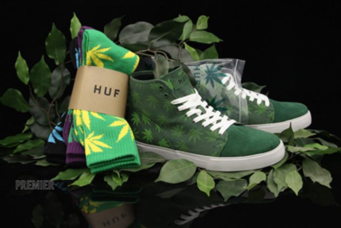Green sneakers next to HUF socks weed shoes