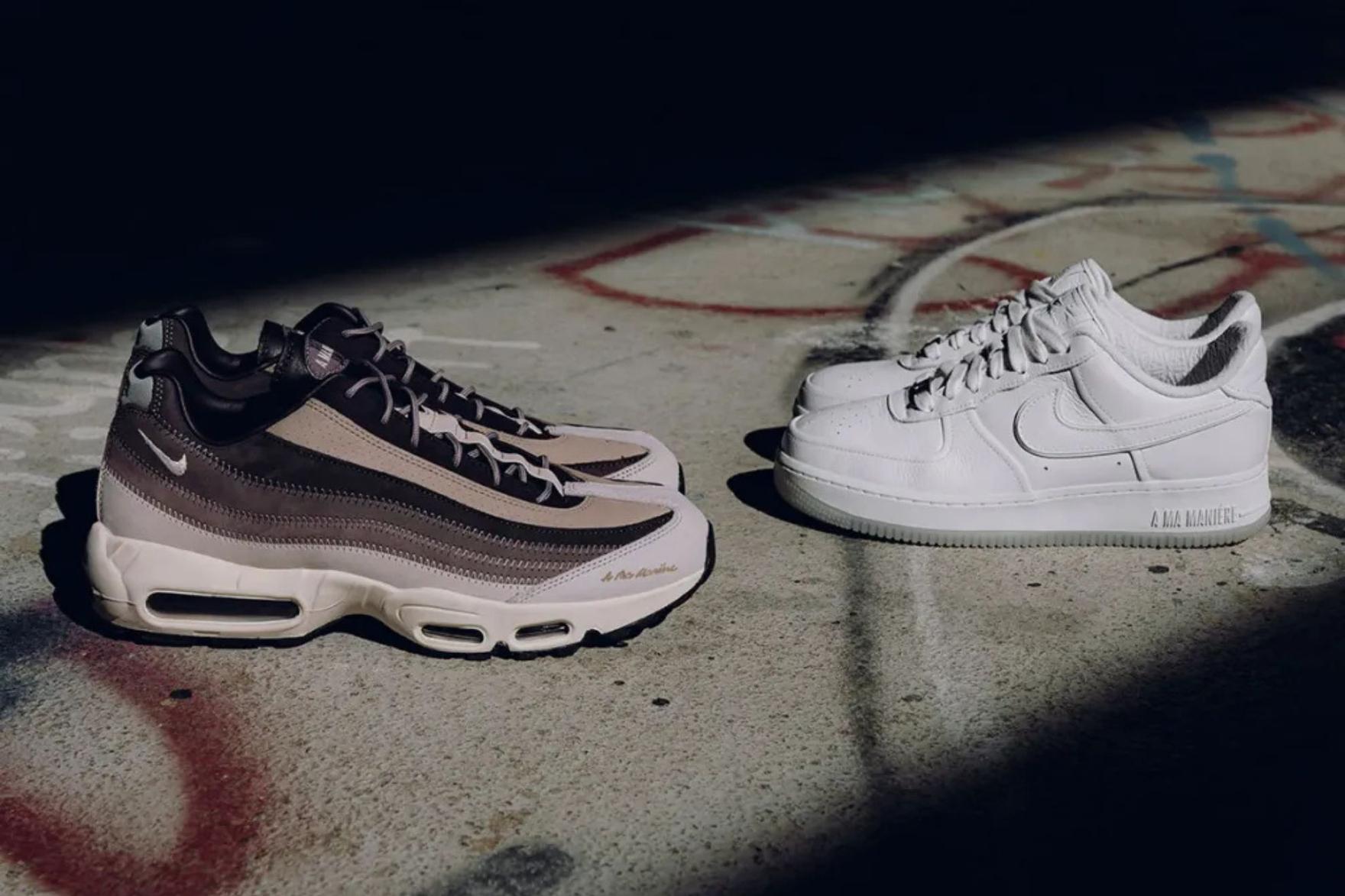 Two pairs of Nike sneakers on a graffitied concrete surface