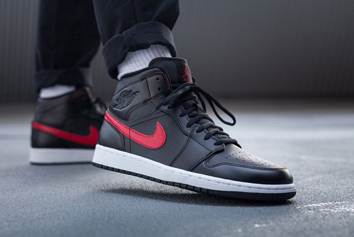 black jordan 1 with red swoosh