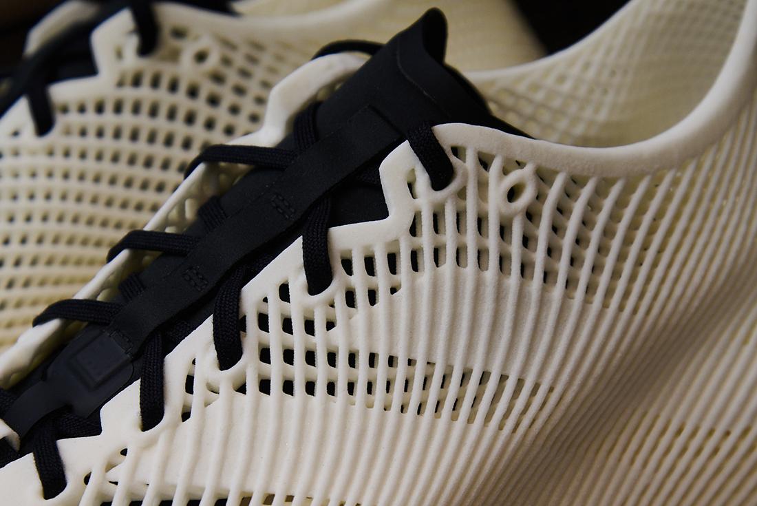 Close-up of black laces and lattice upper of adidas sneaker
