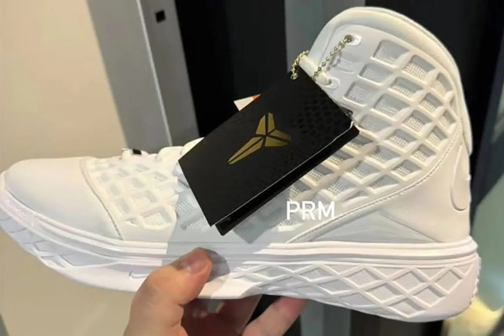 Nike Kobe 3 Protro 'Halo' sneaker in person's hand