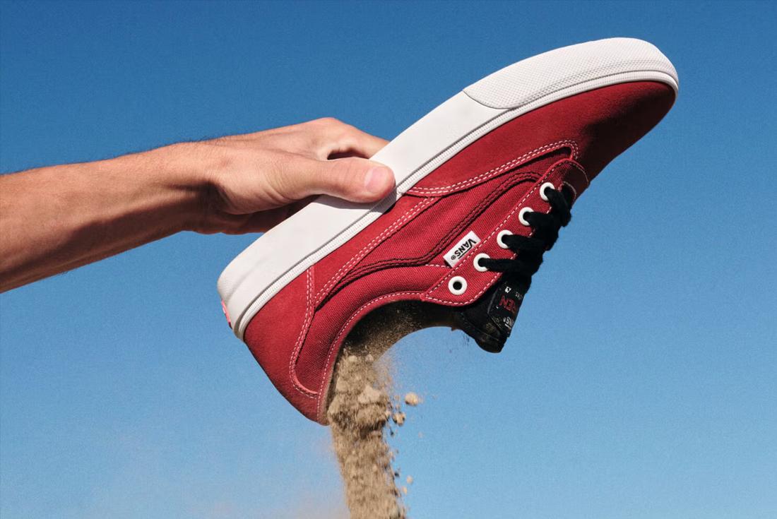 vans curren in hand sand in shoe