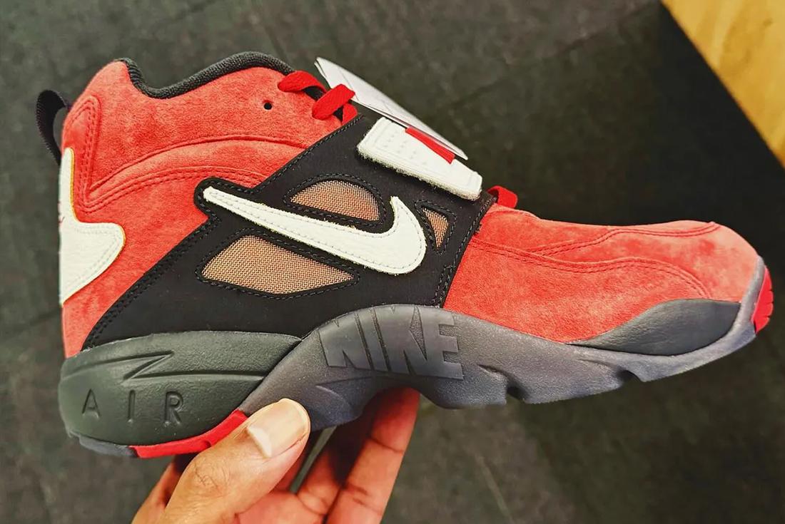 Kid's-sized Deion Sanders Jr Nike sneaker in a person's hand