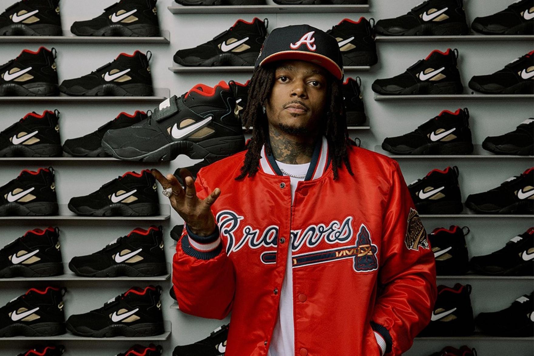 Black Nike Air Diamond Turf Proto 92 on red background