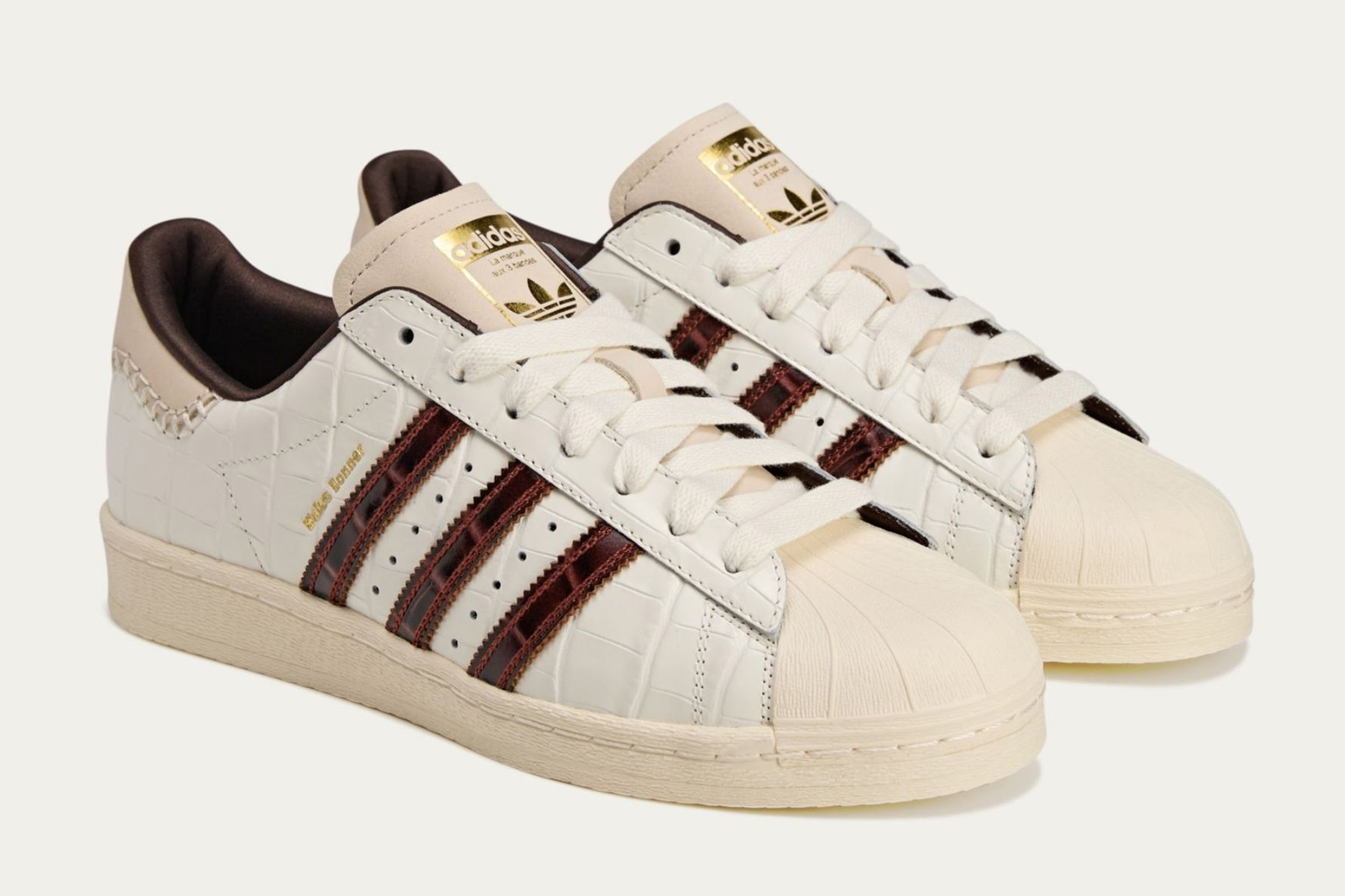 cream and dark brown adidas superstars on cream background