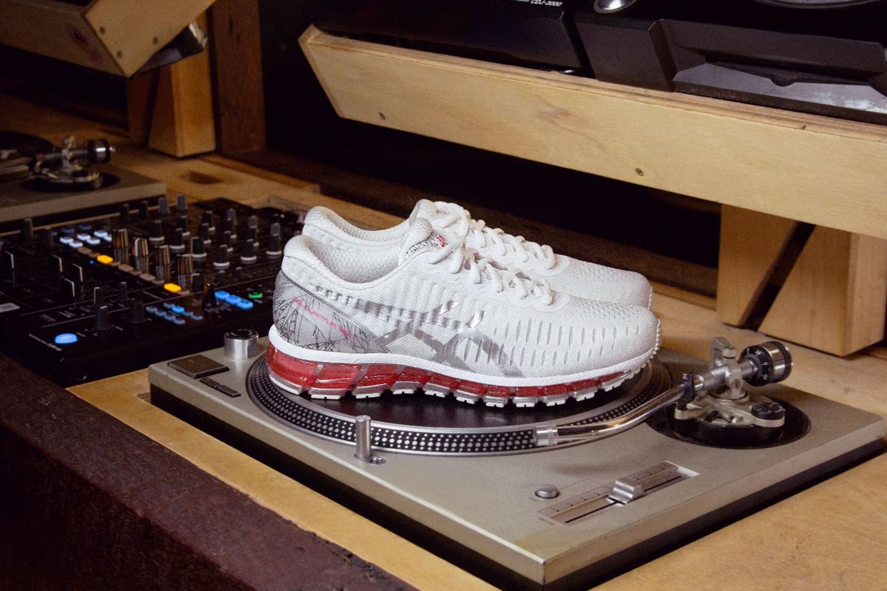 Pink and white ASICS sneakers sitting on a turntable