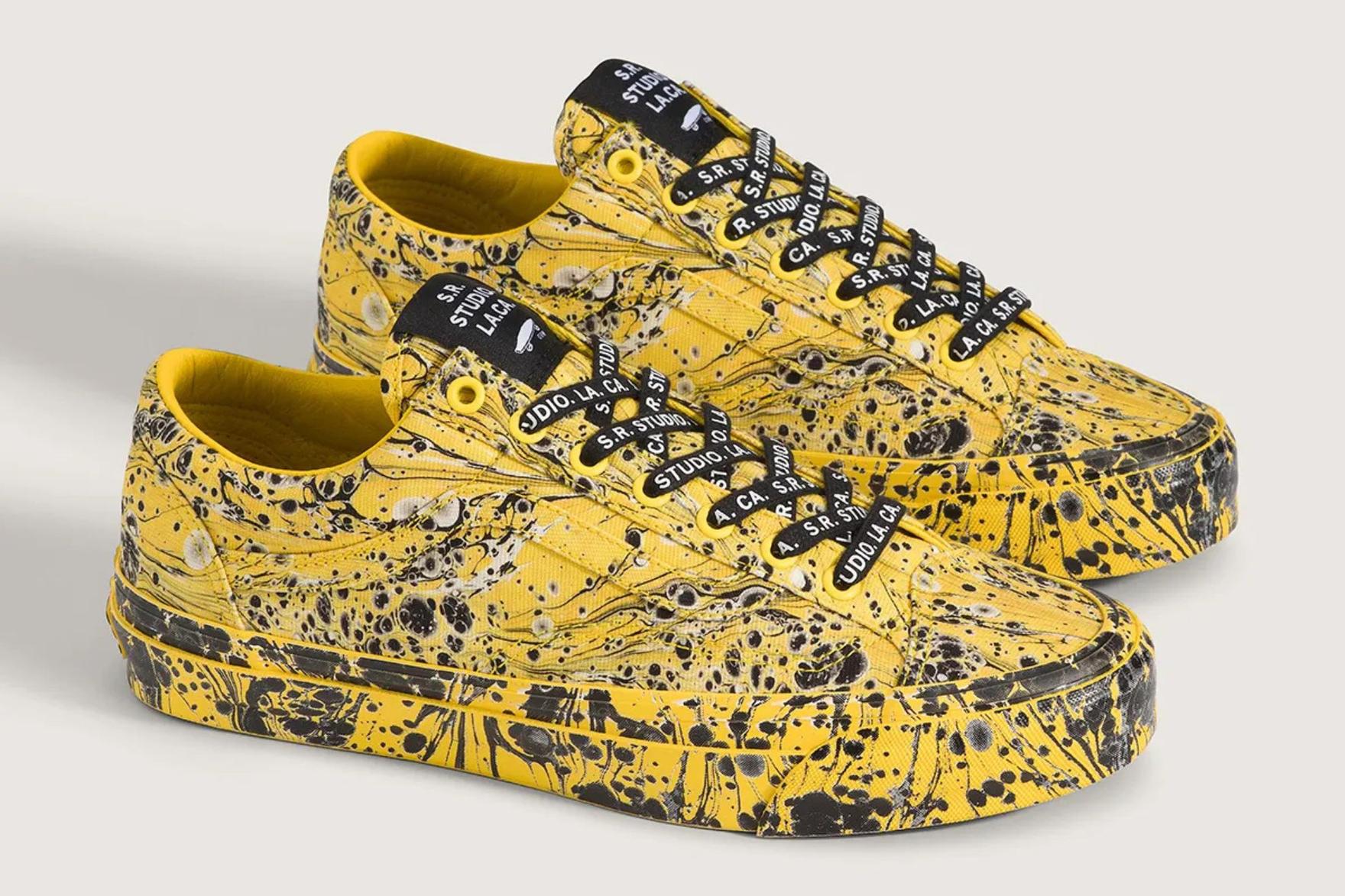 Yellow and black Vans sneakers on grey background