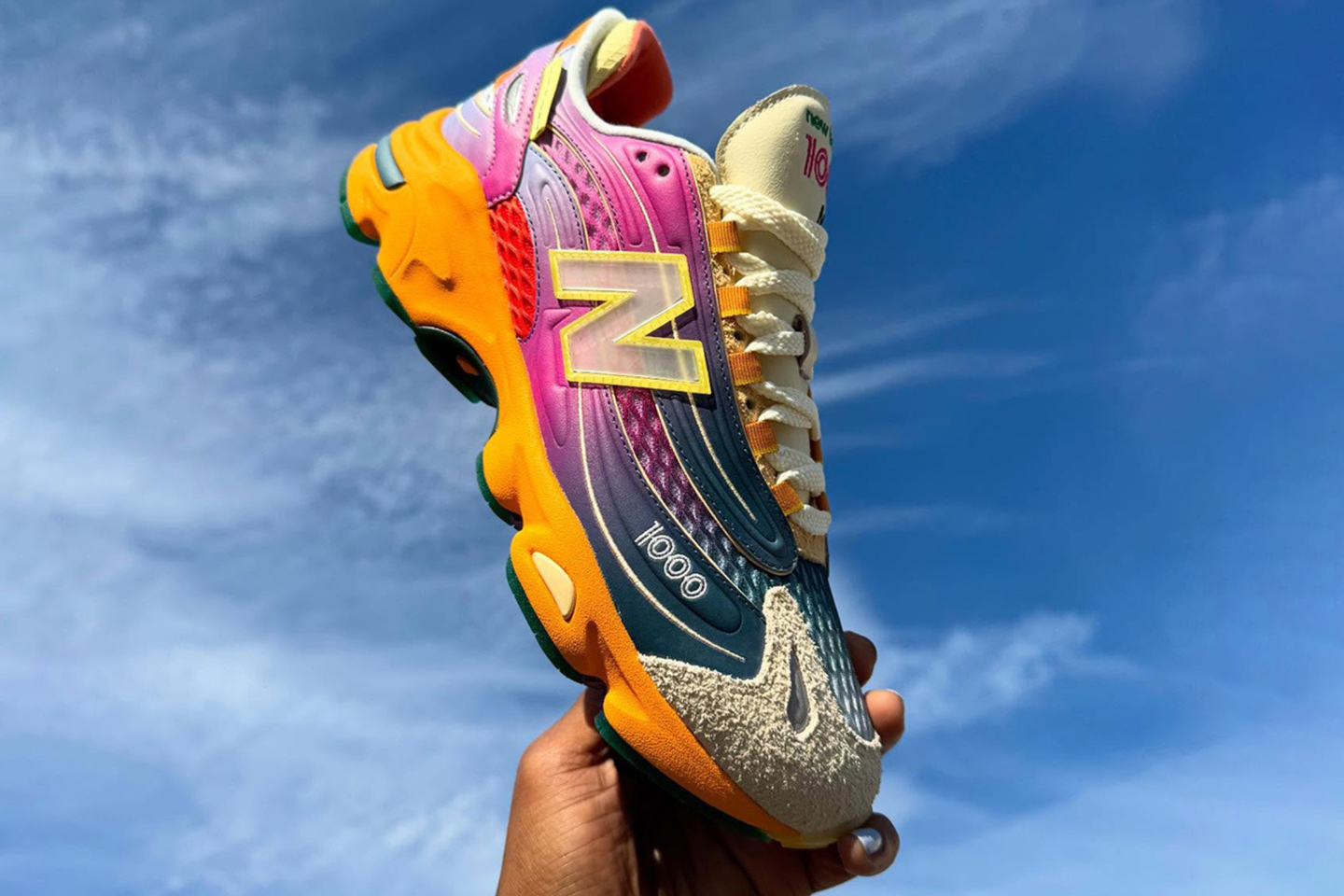 Pink and blue gradient Salehe New Balance 1000 backdropped by clouds
