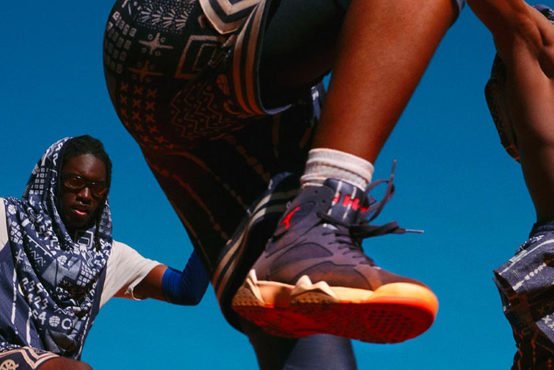 air jordan 7 quai 54 sneaker on-foot against blue sky